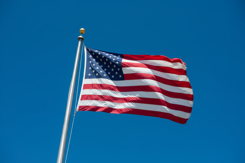 American flag waving on a clear blue sky